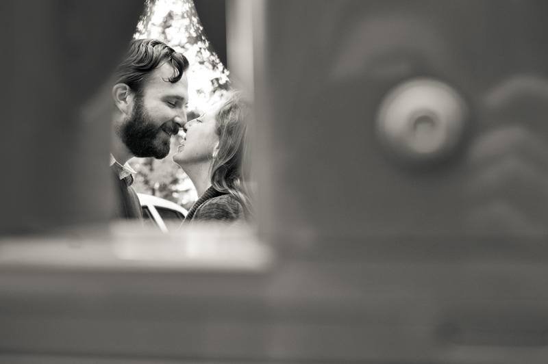 A couple sneaks a kiss as their wedding photographer captures a re-enactment of their first kiss near the Nittany Lion Shrine on the University Park campus.