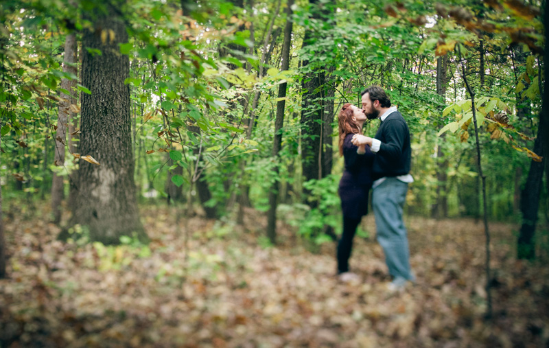 A couple kisses in the trees at the PSU Arboretum near University Park campus