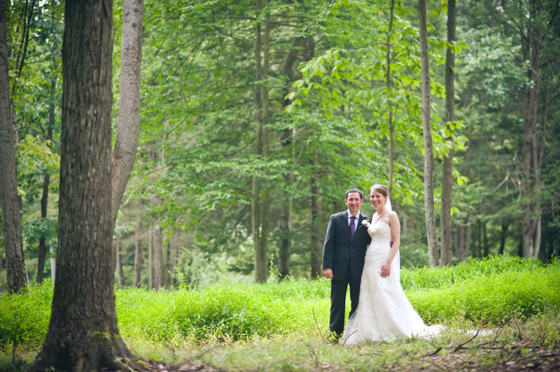 State College Wedding Photographer, Tera Nelson, captures a couple on their wedding day among the trees at the McCann School of Art