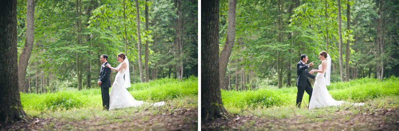 A bride wearing a white dress and long veil and groom in a tuxedo have a first look session under the green leaf trees at the McCann School of Art 
