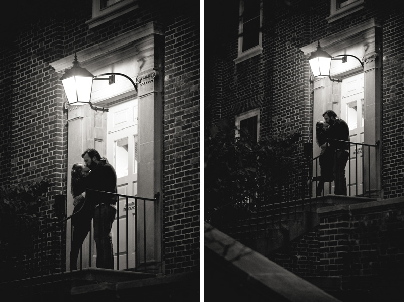 A black and white photographer of a couple preparing for their wedding stops for an evening kiss under the dorm lights near west halls on the University Park campus of PSU.